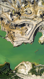 High angle view of coal mine by river on sunny day