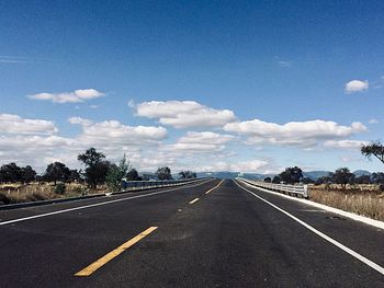 Empty road against sky