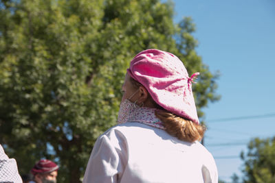 Rear view of woman wearing hat against trees