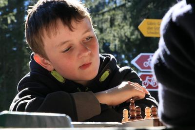 Concentrated boy playing chess