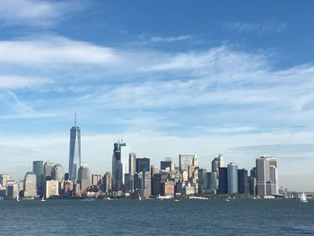 Sea with skyscrapers in background