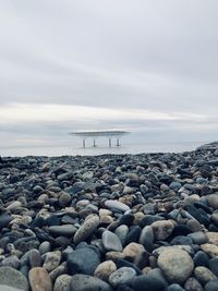 Rocks on beach against sky