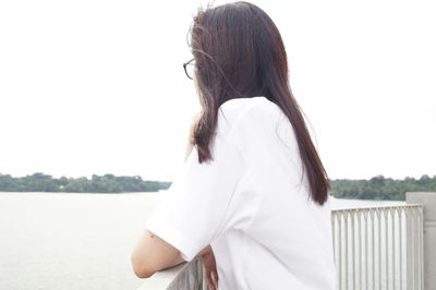 Woman looking at camera against sky