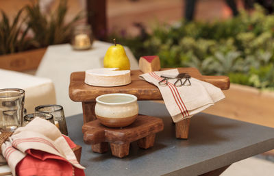 Pear with cheese with kitchen utensil on table