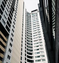 Low angle view of modern buildings in city against sky