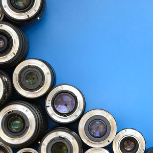 Directly above shot of various lenses on blue background