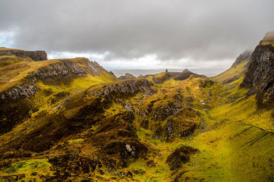 Scenic view of mountains against cloudy sky