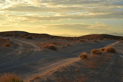 Scenic view of desert against sky during sunset