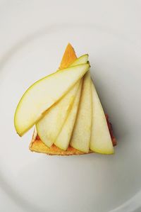 High angle view of apple on plate against white background