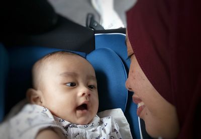 Close-up of mother with cute baby son in vehicle