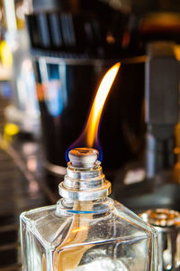 Close-up of burning oil lamp on table