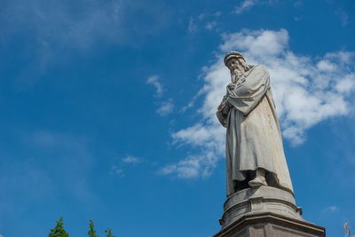 Low angle view of statue against sky