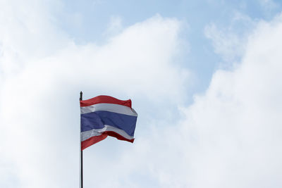 Low angle view of flag flags against sky