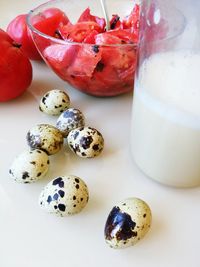 Close-up of eggs with tomatoes and milk on table