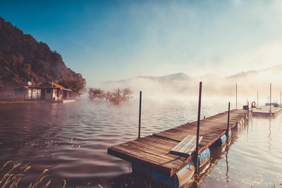 Pier on lake against sky