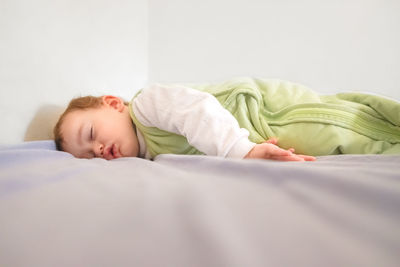Baby girl sleeping on bed