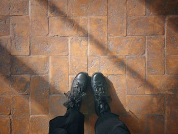 Low section of woman standing on stone floor