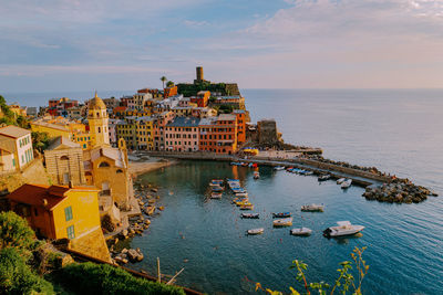 High angle view of buildings and bay against sky