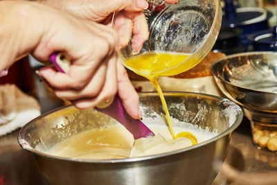 Midsection of man preparing food in glass