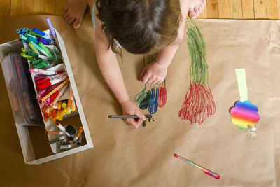 High angle view of woman and drawing on table