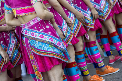 Low section of women standing on road during traditional festival