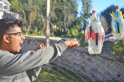 Side view of man punching on lantern