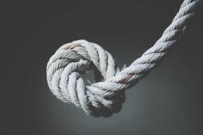 Close-up of rope against gray background
