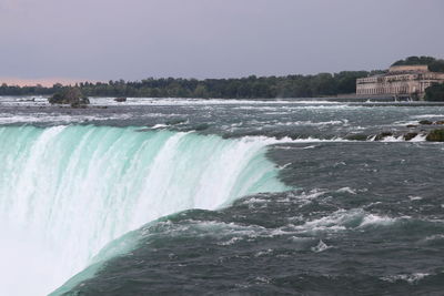 Scenic view of waterfall against clear sky