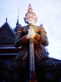 Low angle view of statue of temple against sky