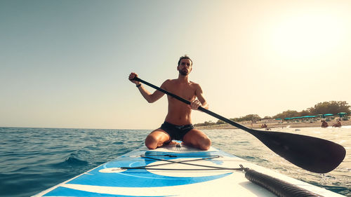 Man sit on a paddle borad