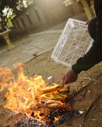 Midsection of person holding bonfire