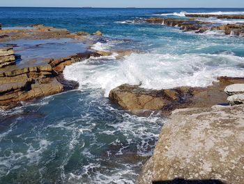 Waves splashing on rocks at shore