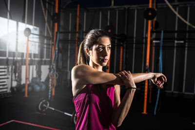 Young woman exercising in gym