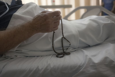 Midsection of man lying on bed