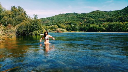 Woman wearing bikini in river