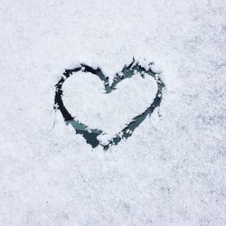 Close-up of heart shape on snow