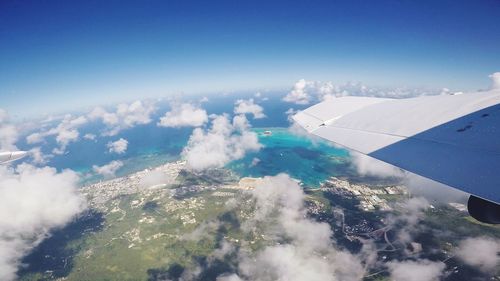 Aerial view of sea and airplane wing