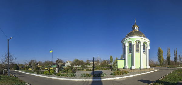 Panoramic shot of buildings against clear blue sky
