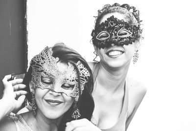 Portrait of two women wearing venice carnival mask.