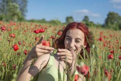 Portrait of woman sitting on field