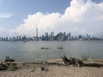 Panoramic view of sea and buildings against sky