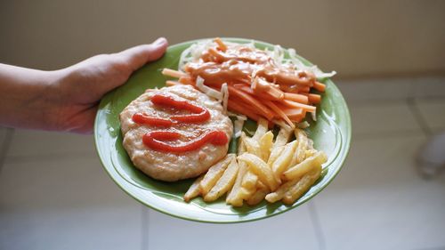 Close-up of hand holding burger