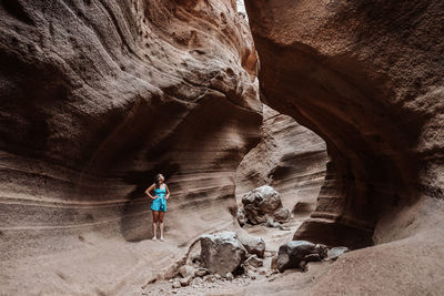 Rear view of man hiking in cave