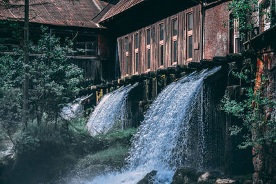 Watermills under houses in forest