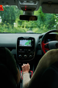 Cropped hand of man driving car