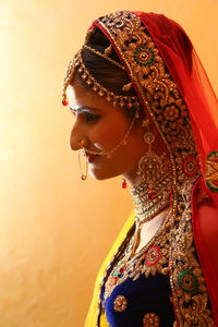 Close-up of bride standing against wall