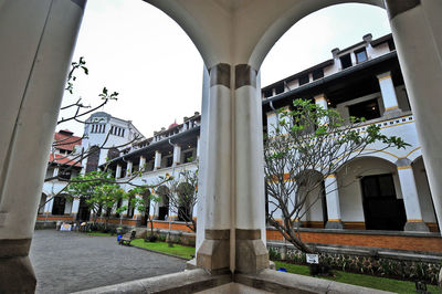 Buildings and street seen through arch bridge