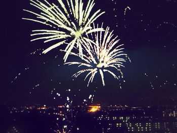 Low angle view of firework display at night