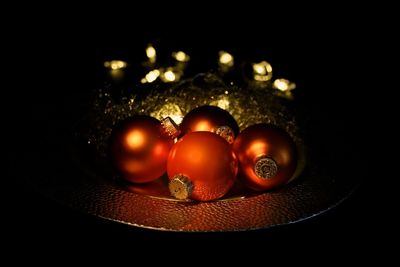 Close-up of light bulb over black background