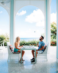 People sitting on chair against sky